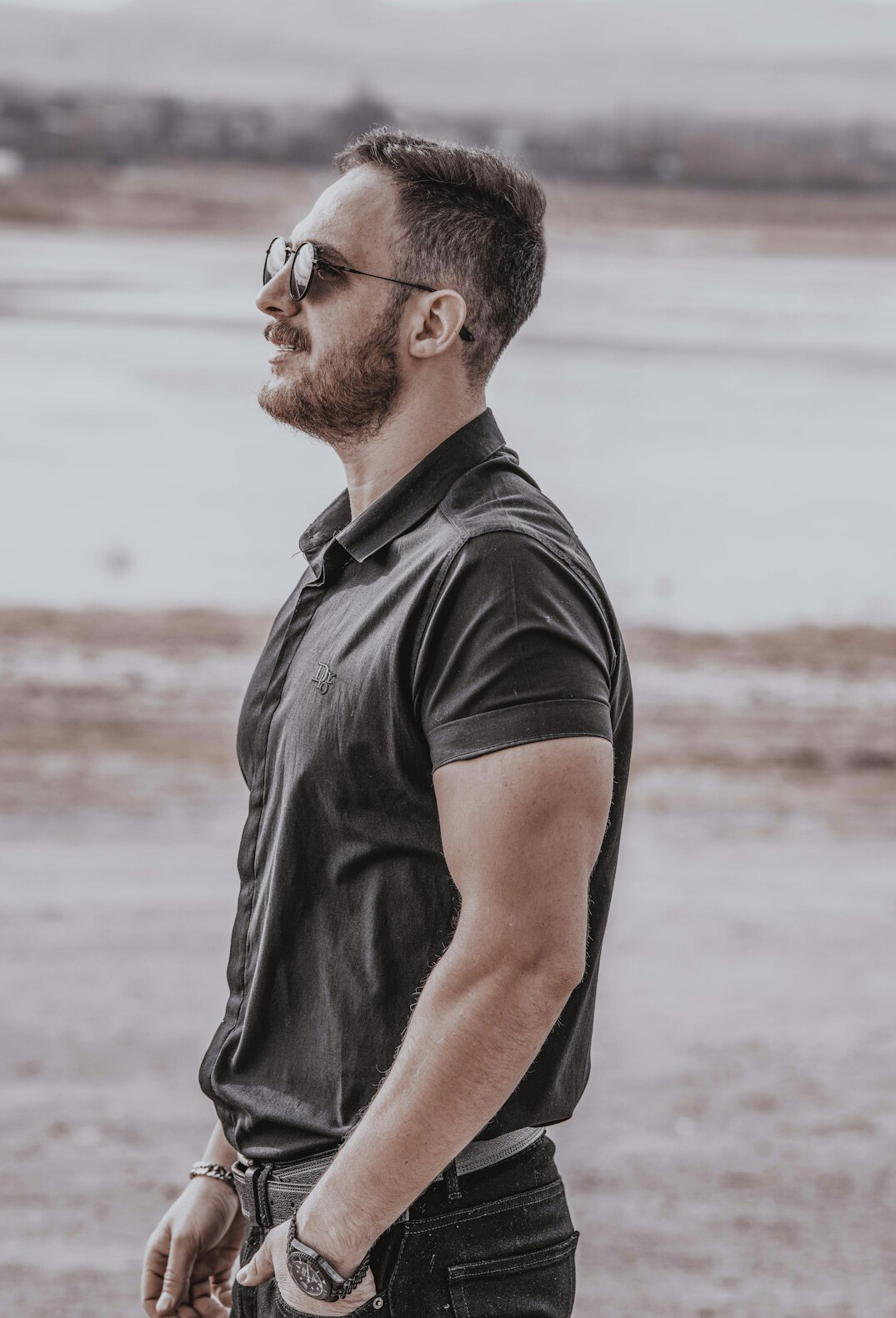 Portrait of a bearded man with short hair in casual shirt